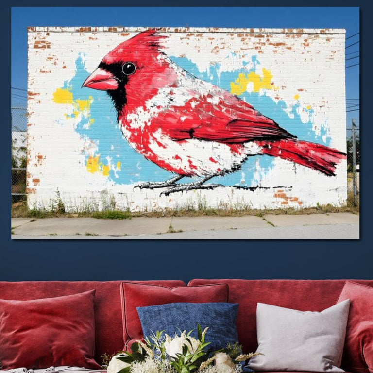 tablou canvas cu o pasare rosie pictata pe un perete de caramida