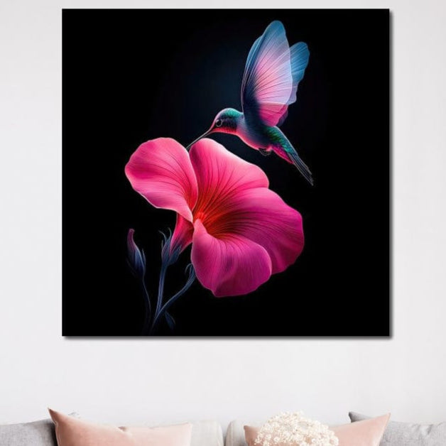 tablou canvas cu o pasare colibri in zbor langa o floare roz intens pe fundal negru