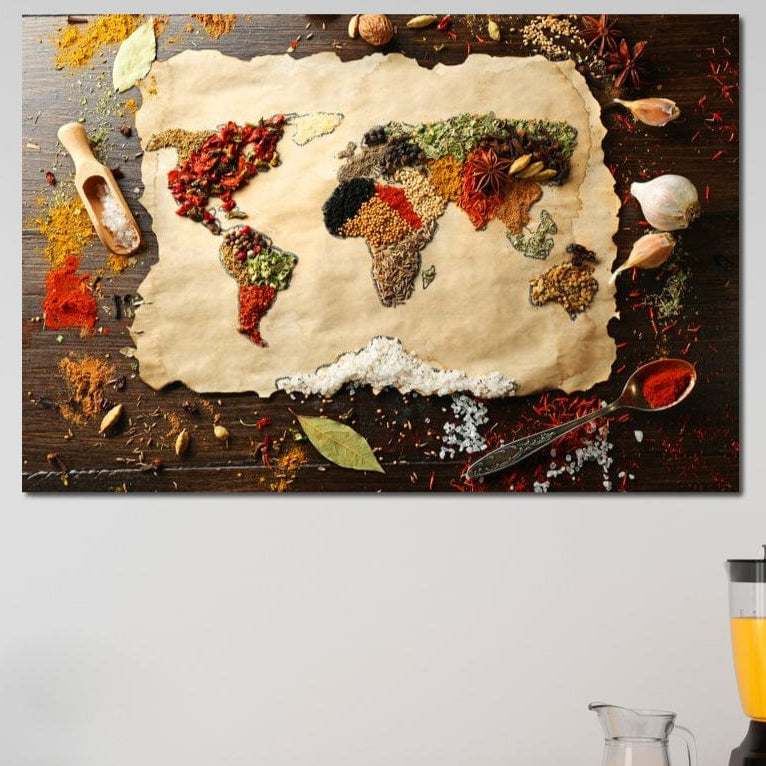 tablou canvas cu harta lumii decorata din mirodenii si condimente, pe o masa de lemn cu plante aromatice si ustensile de bucatarie