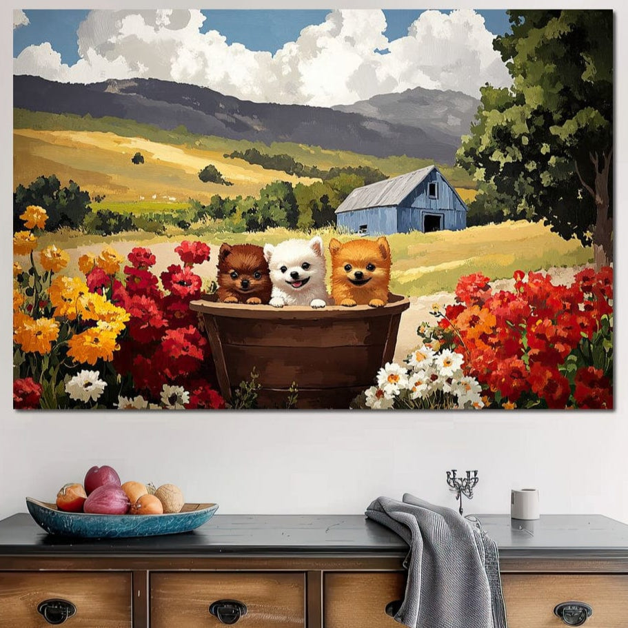 tablou canvas cu trei catelusi intr-un butoias de lemn in mijlocul unei gradini inflorite, pe fundal de dealuri aurii si un hambar albastru