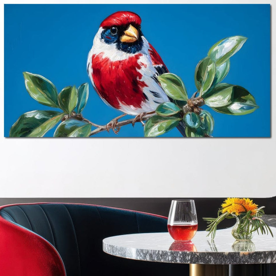 tablou canvas cu o pasare rosie cu accente albe si negre, asezata pe o ramura cu frunze verzi pe fundal de cer senin