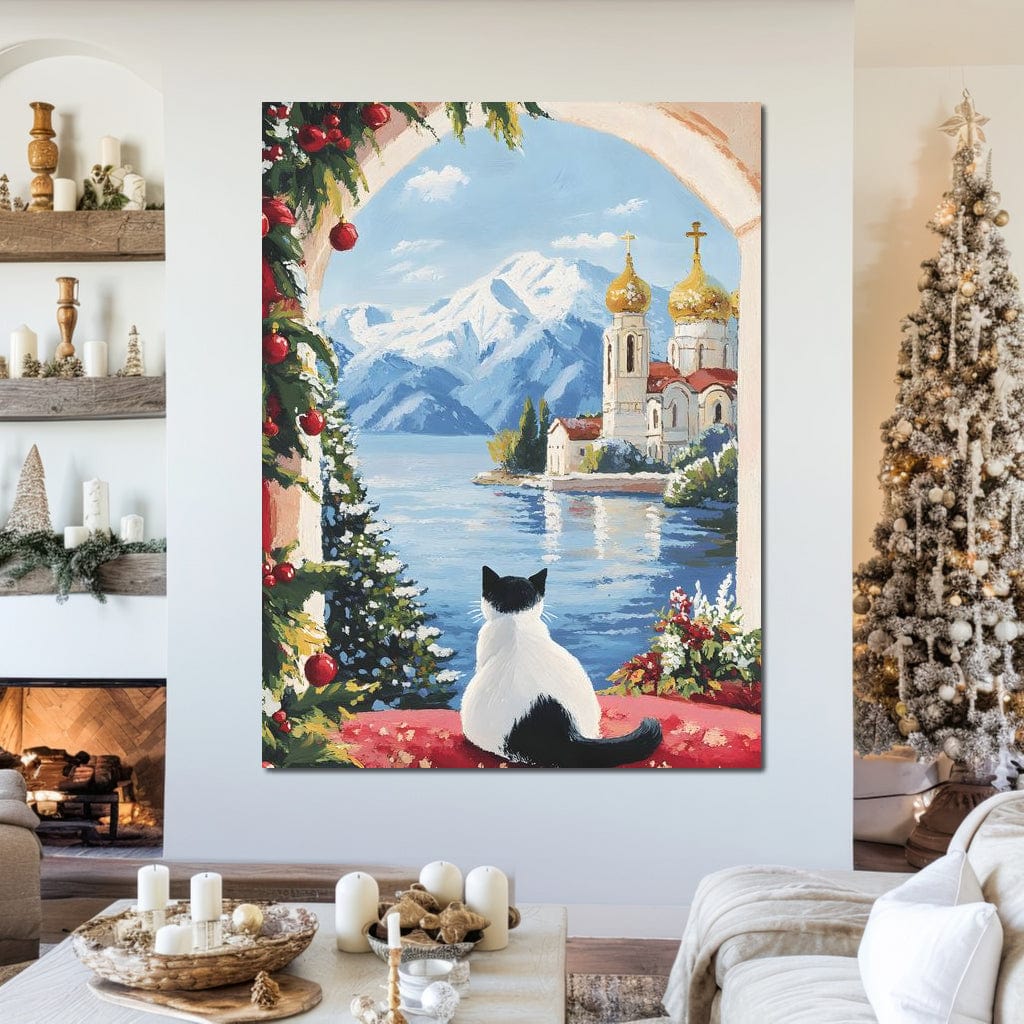 tablou canvas cu o pisica in alb si negru, inconjurata de ornamente de Craciun, privind catre o Biserica dincolo de apa, pe fundal montan
