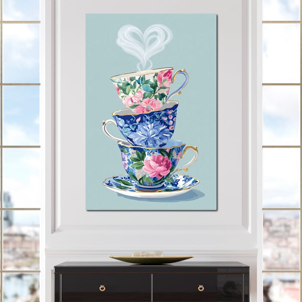 tablou canvas cu trei cesti decorate cu flori si o inima formata din aburi pe fundal albastru pastelat