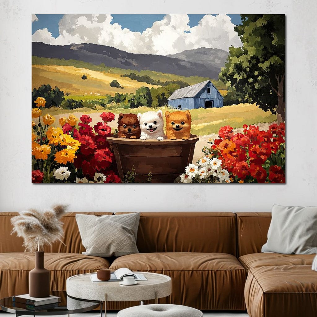 tablou canvas cu trei catelusi intr-un butoias de lemn in mijlocul unei gradini inflorite, pe fundal de dealuri aurii si un hambar albastru