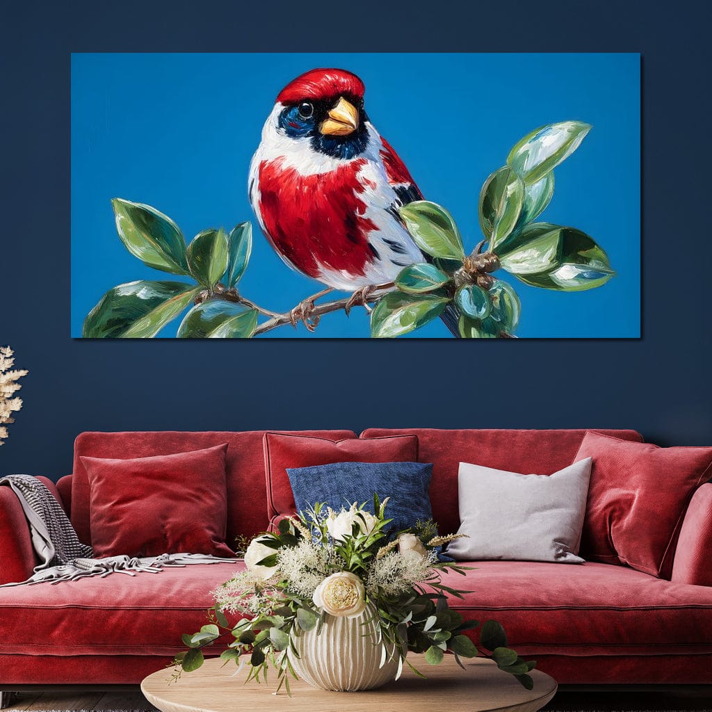 tablou canvas cu o pasare rosie cu accente albe si negre, asezata pe o ramura cu frunze verzi pe fundal de cer senin