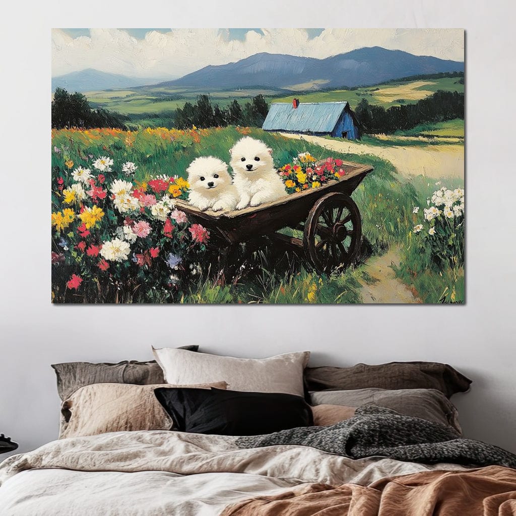 tablou canvas cu doi catelusi albi intr-o roaba plina cu flori, pe fundal idilic de campuri verzi si munti 