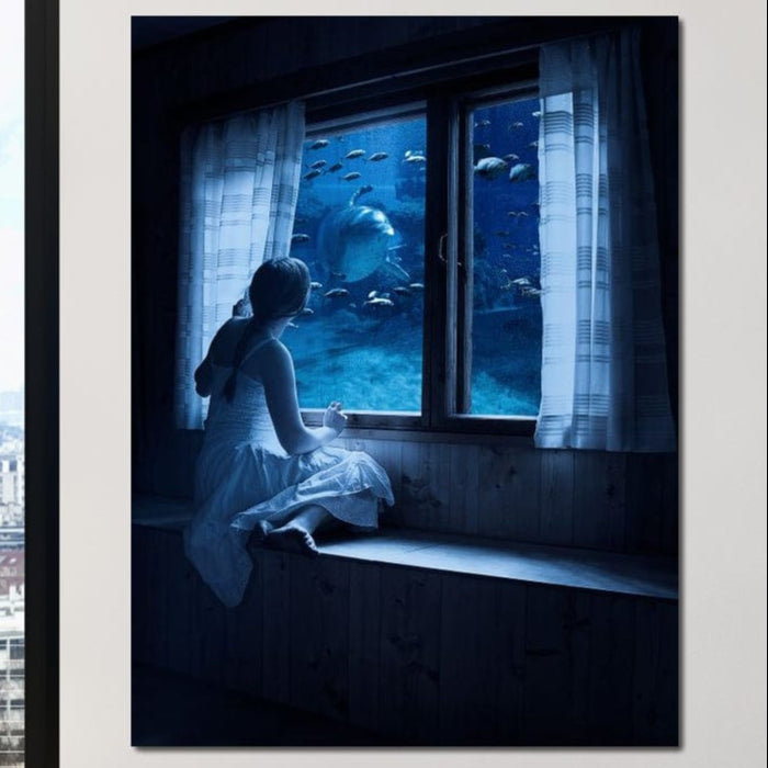 tablou canvas cu un copil privind adancurile oceanului cu pesti si rechini printr-o fereastra
