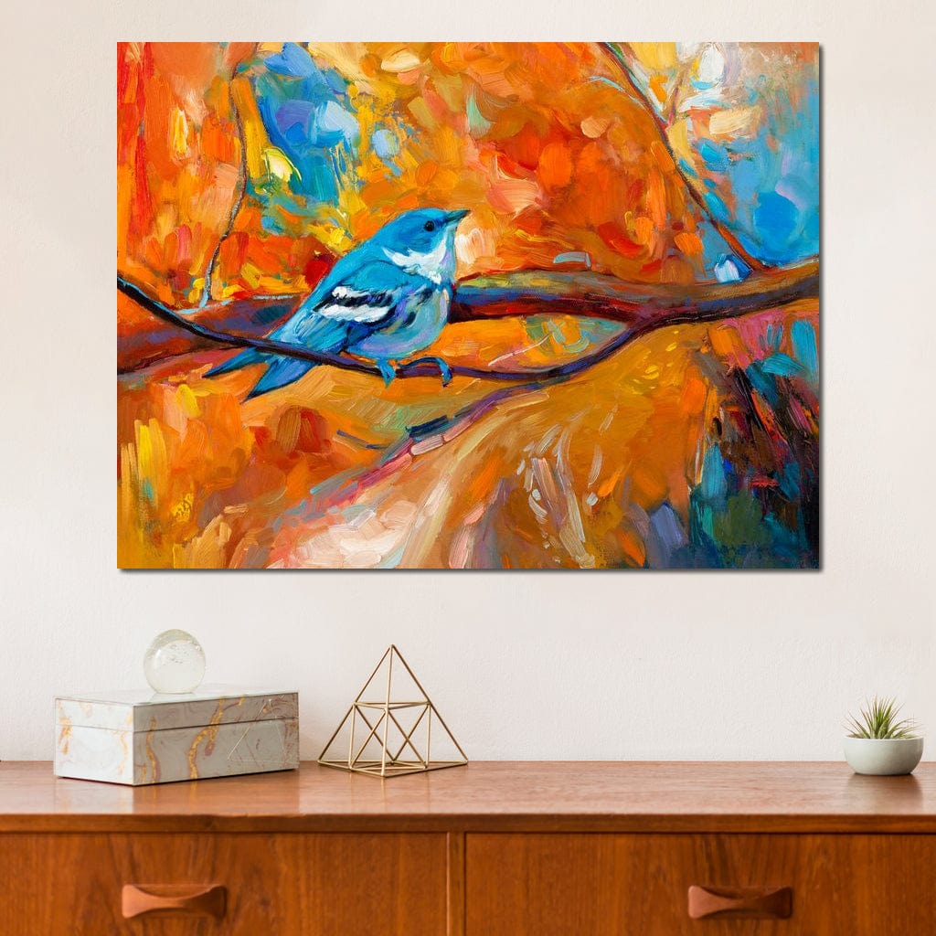 tablou canvas cu o pasare albastra pe creanga, in peisaj de toamna colorat