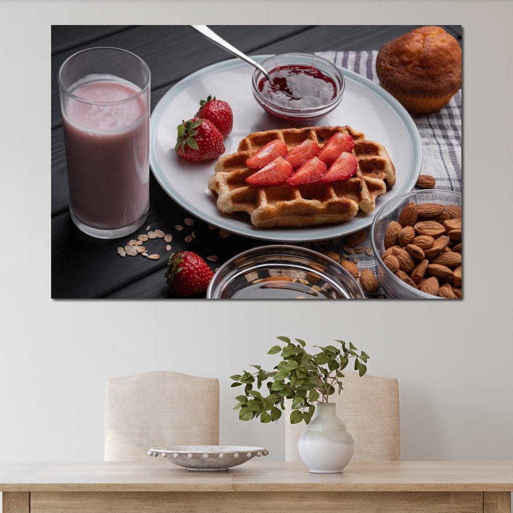 tablou canvas cu un mic dejun dulce, cu o vafa si capsuni, o briosa, migdale si un milkshake, pe o masa de lemn neagra