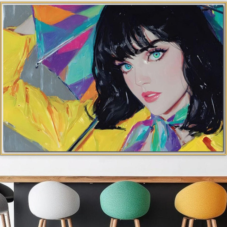 O pânză vibrantă LuxCanva® Tablou Canvas Premium (G1216) prezintă o femeie cu păr negru, ochi turcoaz și buze roz care ține o umbrelă curcubeu într-o haină galbenă, perfectă deasupra scaunelor moderne multicolore pentru saloane, birouri sau spații de locuit.