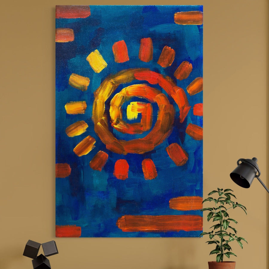 Pânza Tablou Premium LuxCanva® A1265, care prezintă un soare abstract cu portocaliu și galben vibrante pe albastru, adaugă culoare decorului dormitorului dvs. deasupra unei plante mici și a unei lămpi de birou negre.