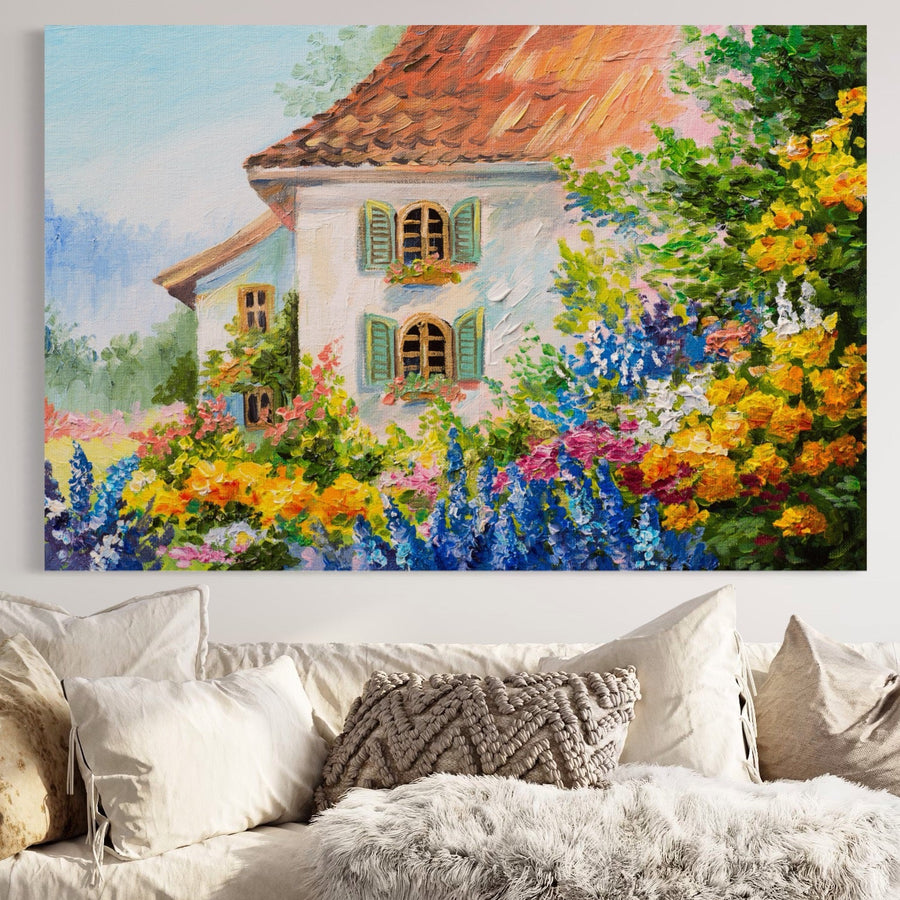 Tabloul LuxCanva® Tablou Canvas Premium A1109, care prezintă "Casa Din Gradina" cu flori galbene vibrante și o căsuță fermecătoare, adaugă frumusețe colorată deasupra unei canapele bej împodobite cu perne texturate și pufoase.