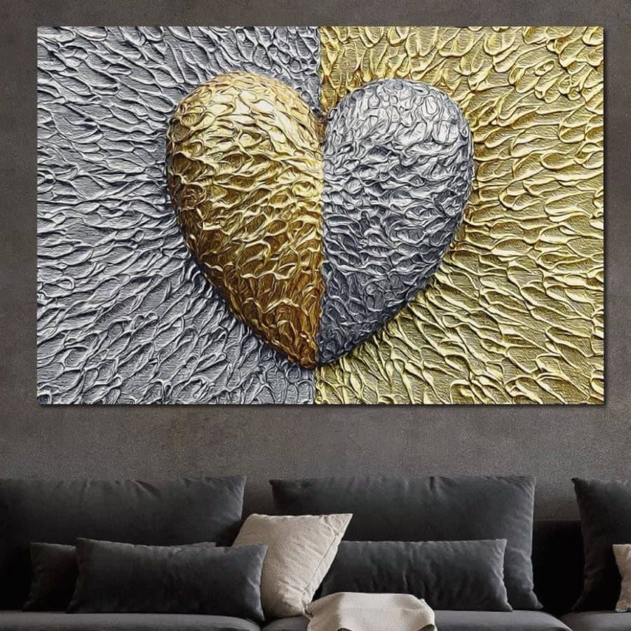 The LuxCanva® Tablou Canvas Premium E1053, Inima Dualitatii, prezintă o inimă cu jumătate aur, jumătate argint pe fundaluri asortate. Acest tablou vibrant și texturat decorează deosebit livingul, așezat deasupra unei canapele gri închis cu perne neutre.