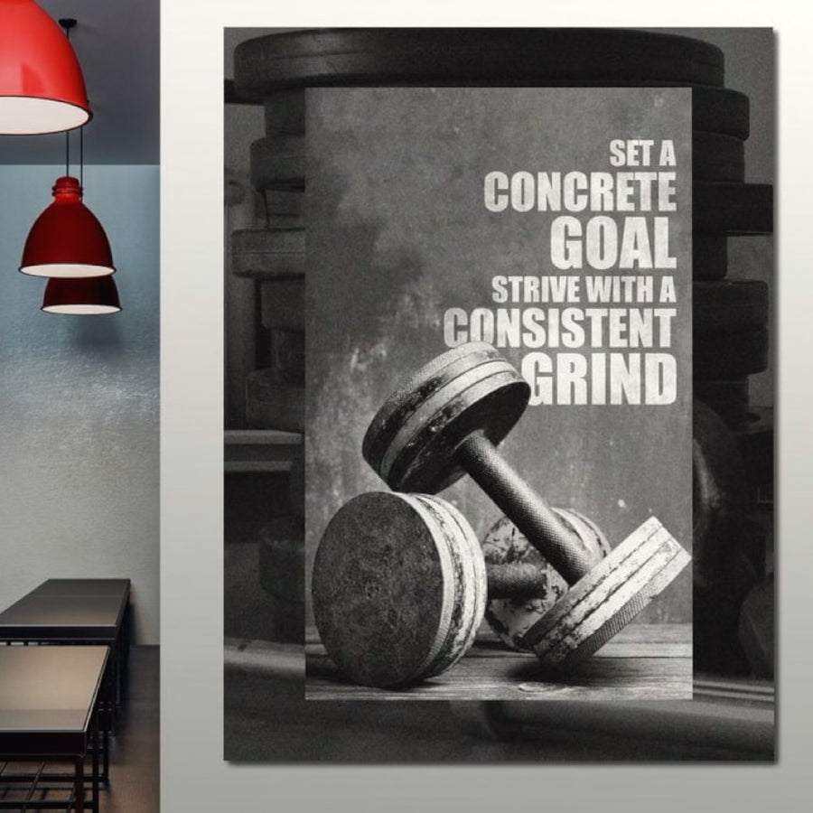 Tabloul LuxCanva® Tablou Canvas Premium F1020 prezintă două haltere și textul: "Stabiliți-vă un obiectiv concret. Străduiți-vă cu un efort constant". Perfect pentru sălile de sport, spațiile de locuit sau birouri, inspiră putere și perseverență cu o calitate de imprimare premium.