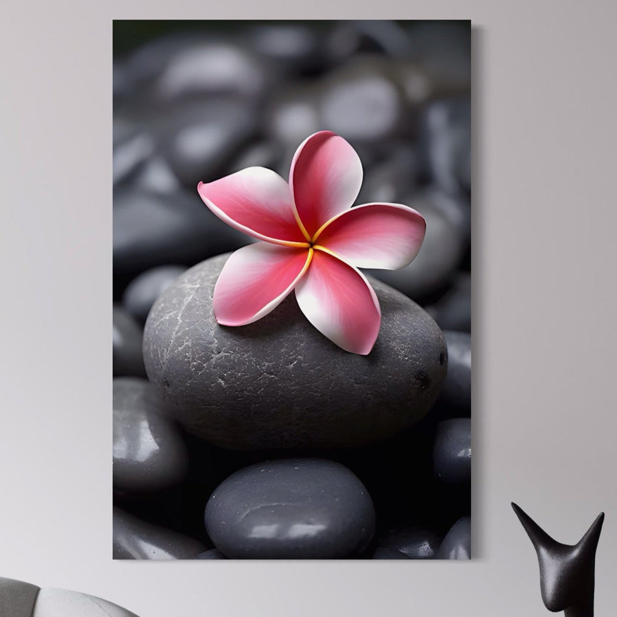 Afișat deasupra unui scaun modern și a unui decor negru, Tablou Canvas Premium LuxCanva® A1498 prezintă flori și pietre roz vibrante, perfecte pentru o relaxare de tip spa în camera ta de zi. Brand: LuxCanva®.