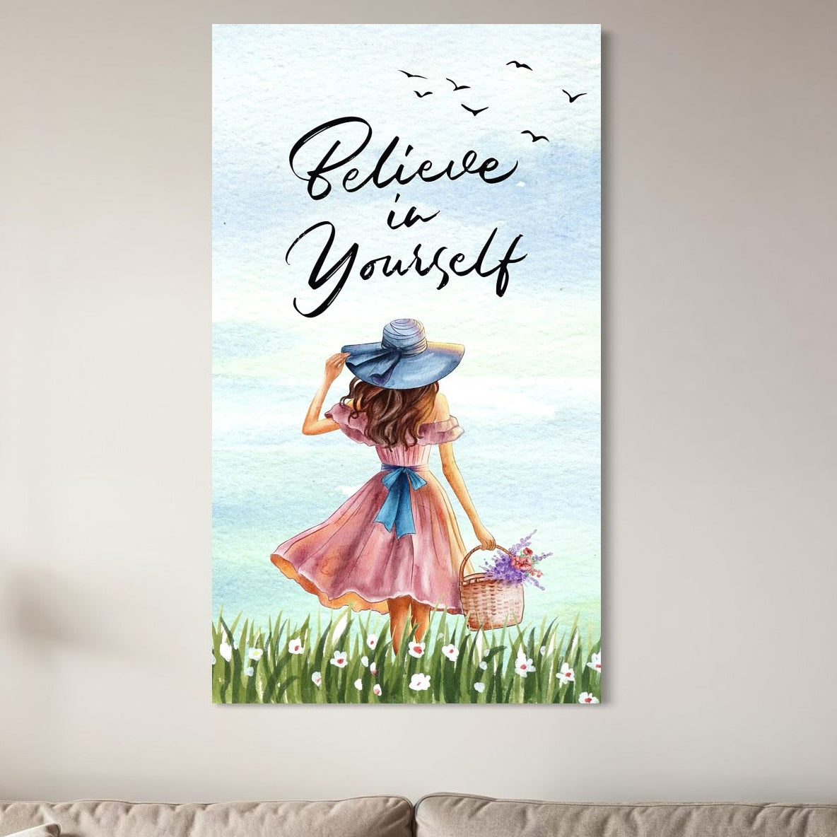 tablou canvas cu o fata cu rochie roz si palarie albastra, cu un cos cu flori colorate, pe fundal cu cer senin si un mesaj motivational