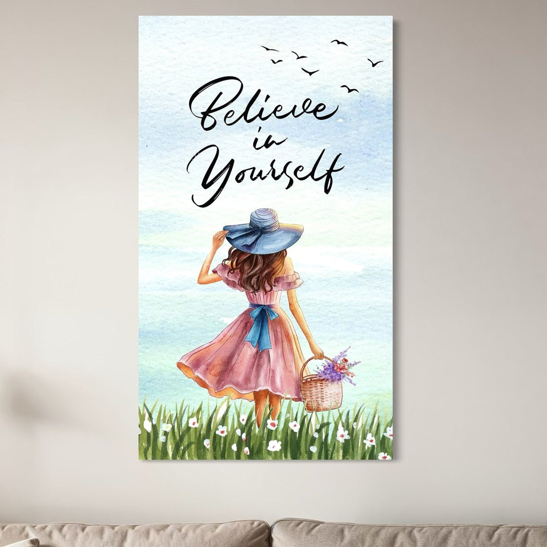 tablou canvas cu o fata cu rochie roz si palarie albastra, cu un cos cu flori colorate, pe fundal cu cer senin si un mesaj motivational