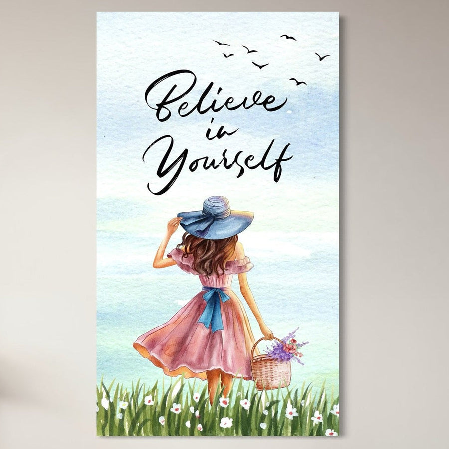 tablou canvas cu o fata cu rochie roz si palarie albastra, cu un cos cu flori colorate, pe fundal cu cer senin si un mesaj motivational