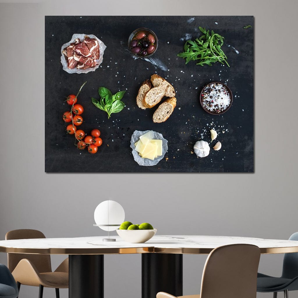 tablou canvas cu bruschette, rosii cherry, verdeturi, condimente si prosciutto pe o masa neagra