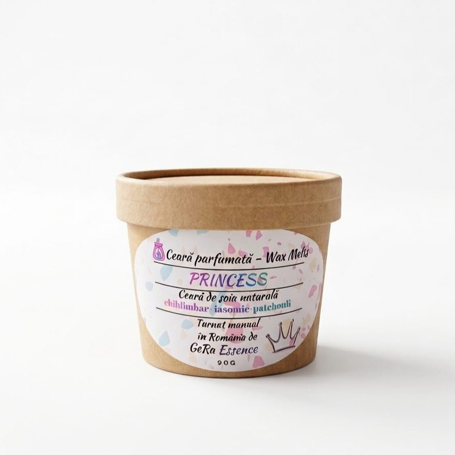 Un recipient din hârtie maro, etichetat LuxCanva®, conține 90 g de ceară topită din soia făcută manual, GeRa Essence Princess (Chihlimbar, Iasomie, Patchouli), cu accente pastelate și text românesc, care promite un parfum senzual și feminin din ingrediente naturale.